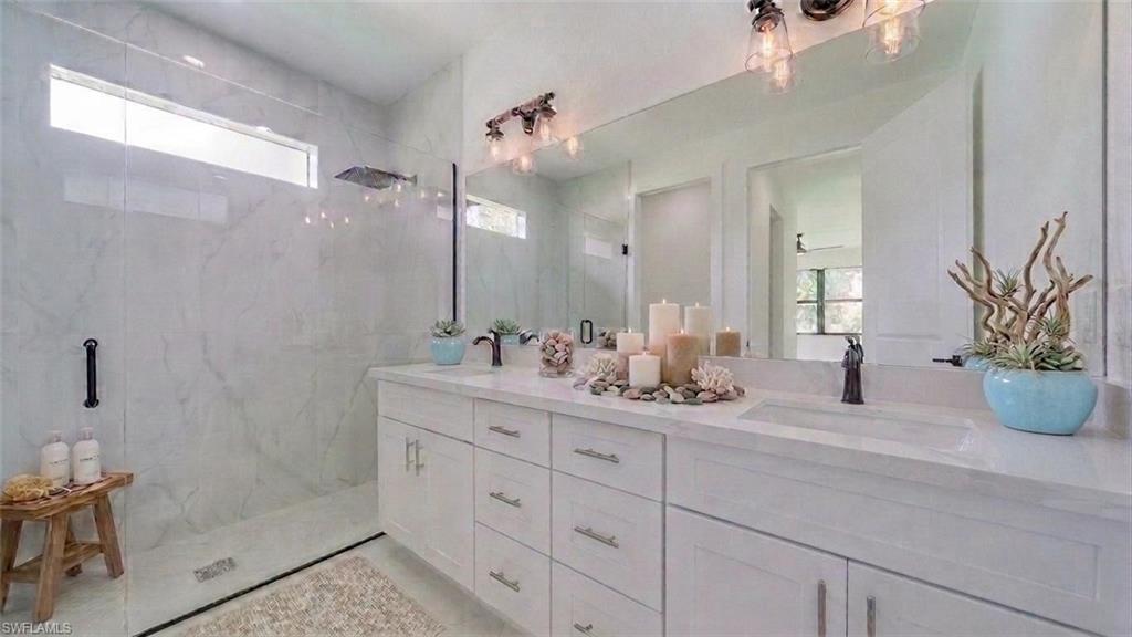 Dual vanity/sinks with a gorgeous all tile walk-in rain shower! (Virtually staged)