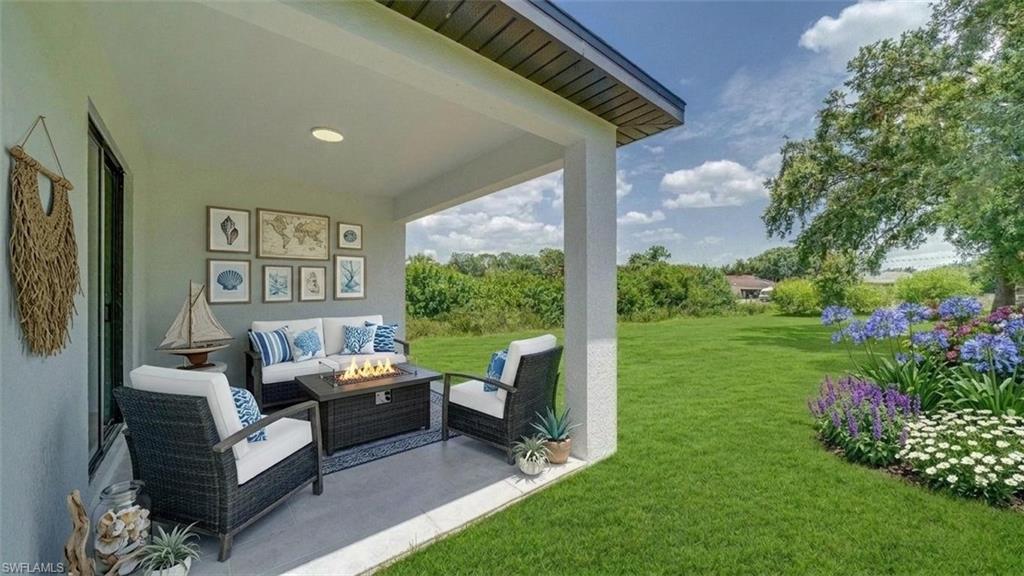Another view of the lanai and backyard. No neighbor in the back! (Virtually staged & enhanced)