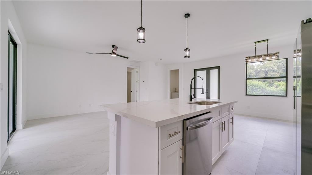 Another view from the kitchen showing the great room. Door on far wall leads to the Primary Suite.