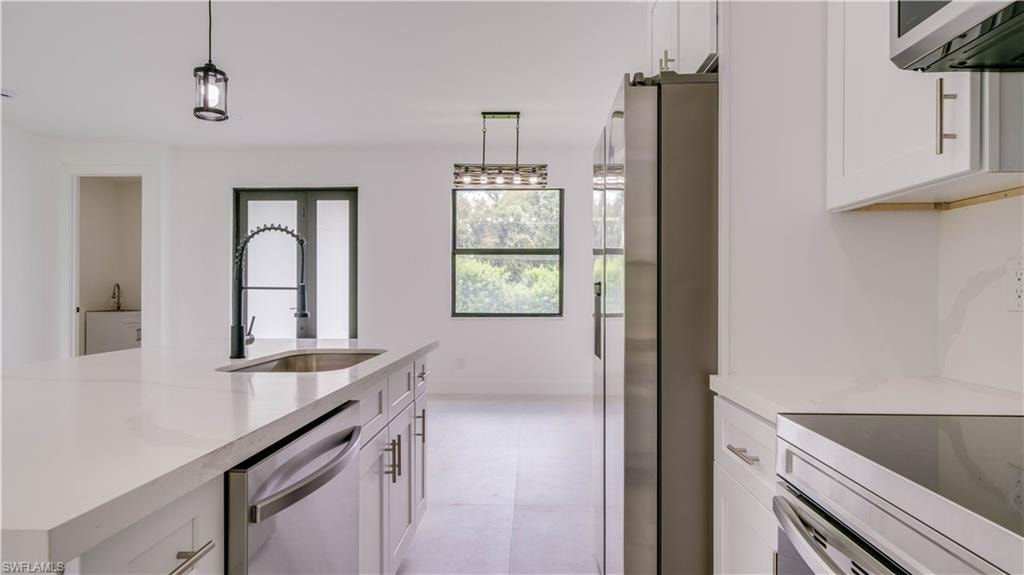 View from kitchen of front door. Laundry room is to the left. Dining area straight ahead.