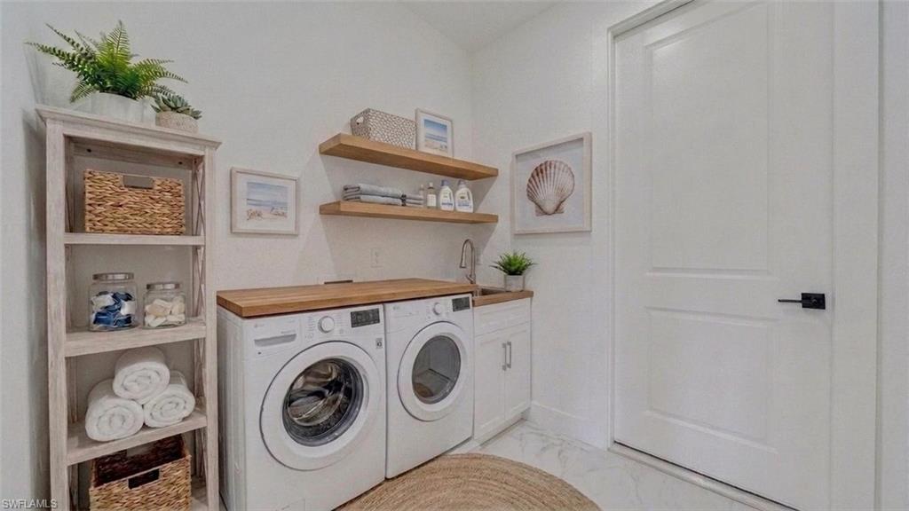 Laundry room leads to the garage. (Virtually staged)