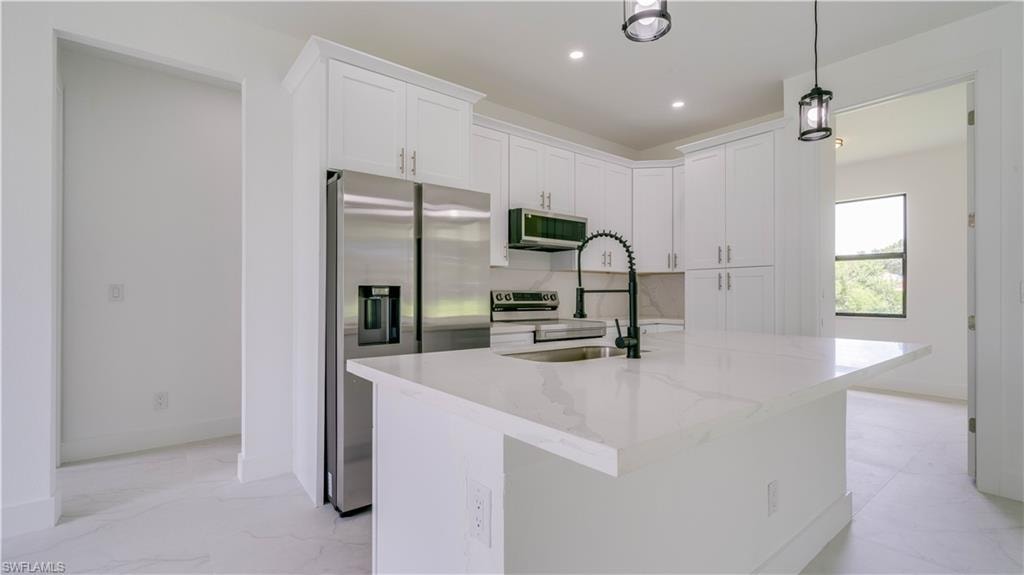 Gorgeous cabinetry and quartz countertops & Island. The open door to the right leads to your office/den!