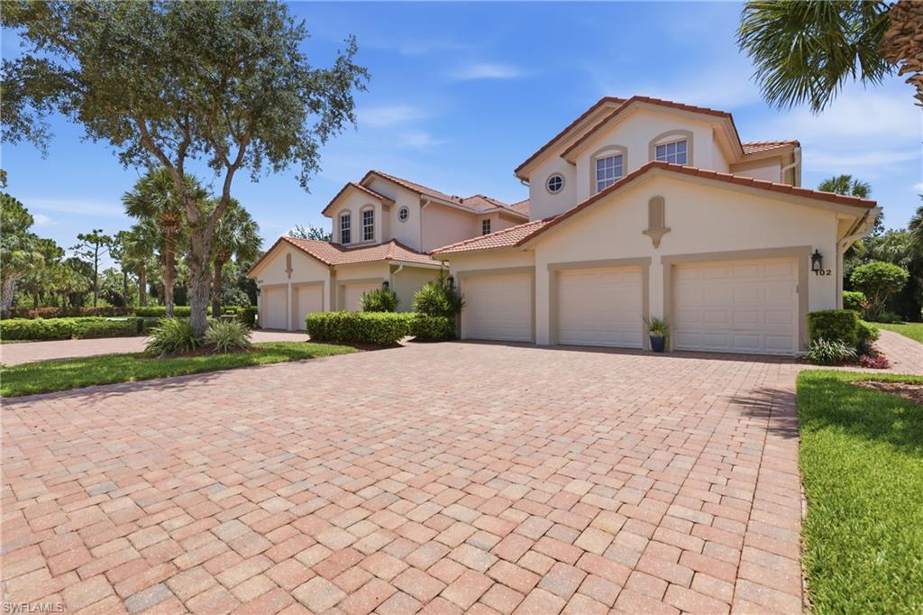 Mediterranean-style residence featuring a tile roof and stucco exterior