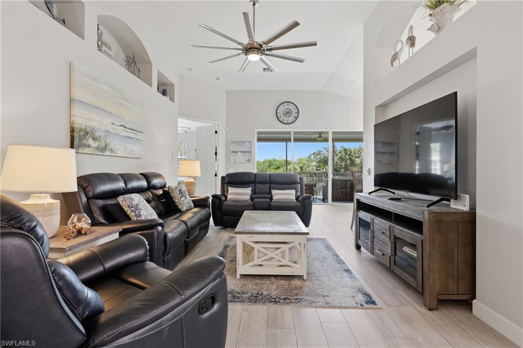 Spacious living area featuring vaulted ceilings and light wood-finish flooring