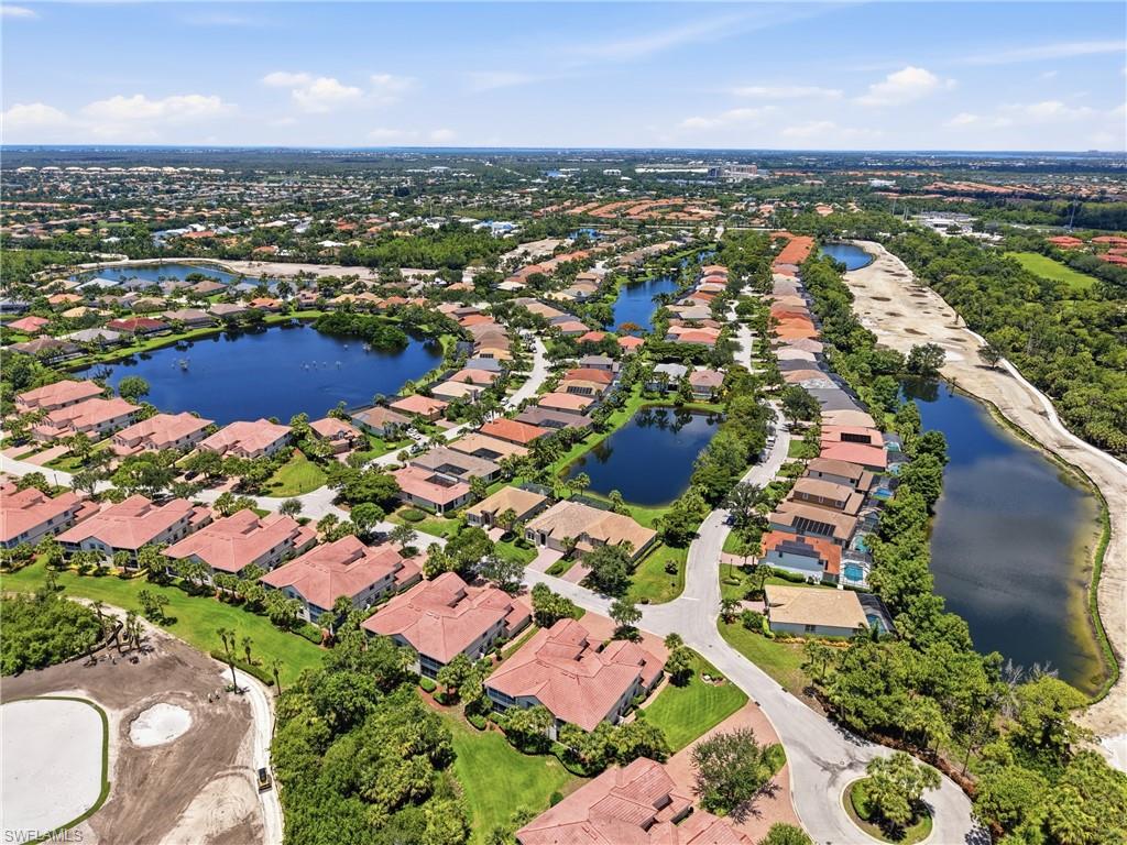 Aerial perspective showcasing a residential community with numerous properties featuring terracotta-style roofs
