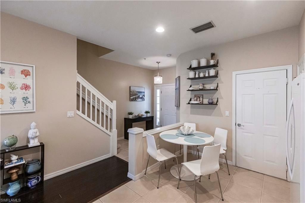 Dining area featuring stairway, recessed lighting, and light tile patterned floors