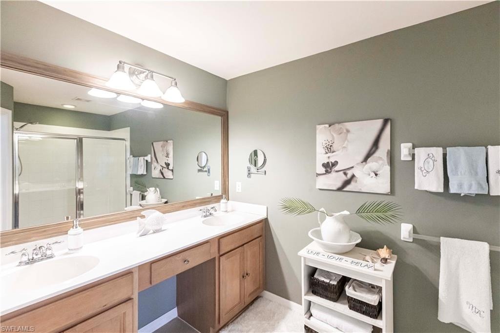 Bathroom with double vanity and a shower stall