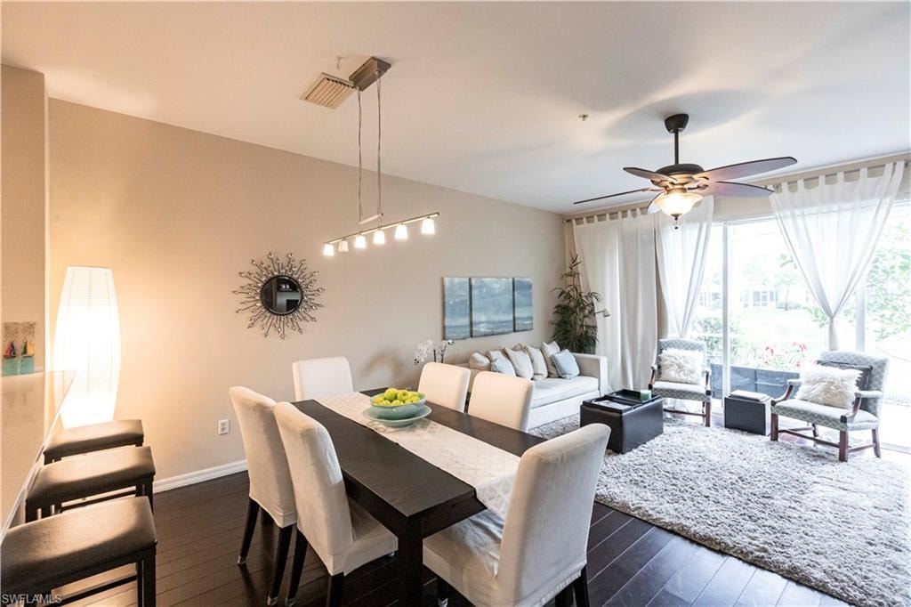 Dining room with a ceiling fan and dark wood-style flooring