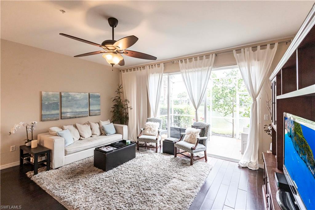 Living room featuring dark wood finished floors and ceiling fan
