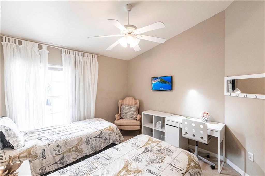 Bedroom with lofted ceiling, carpet, and ceiling fan