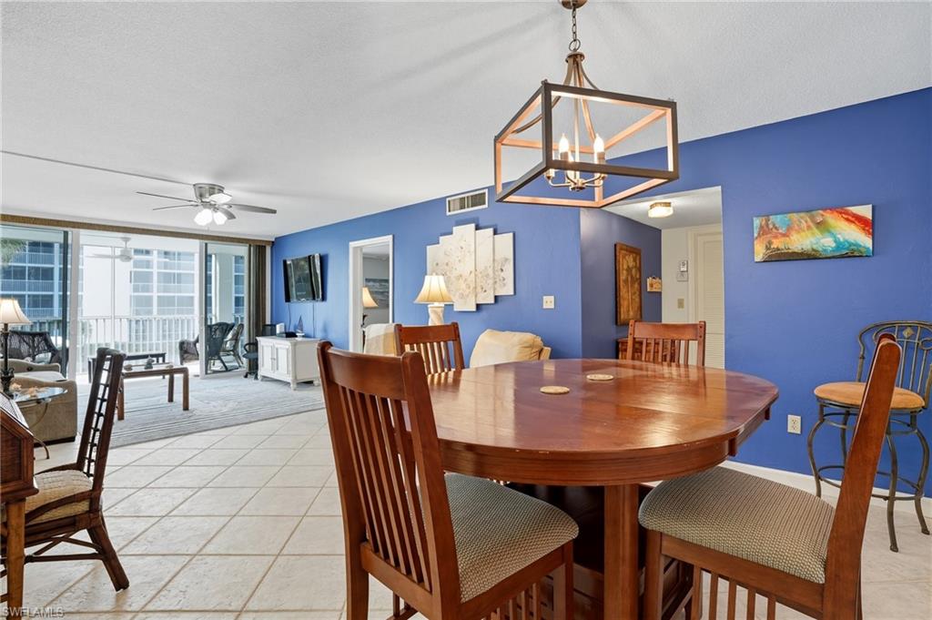 Open-concept living area with tile flooring and a blue accent wall