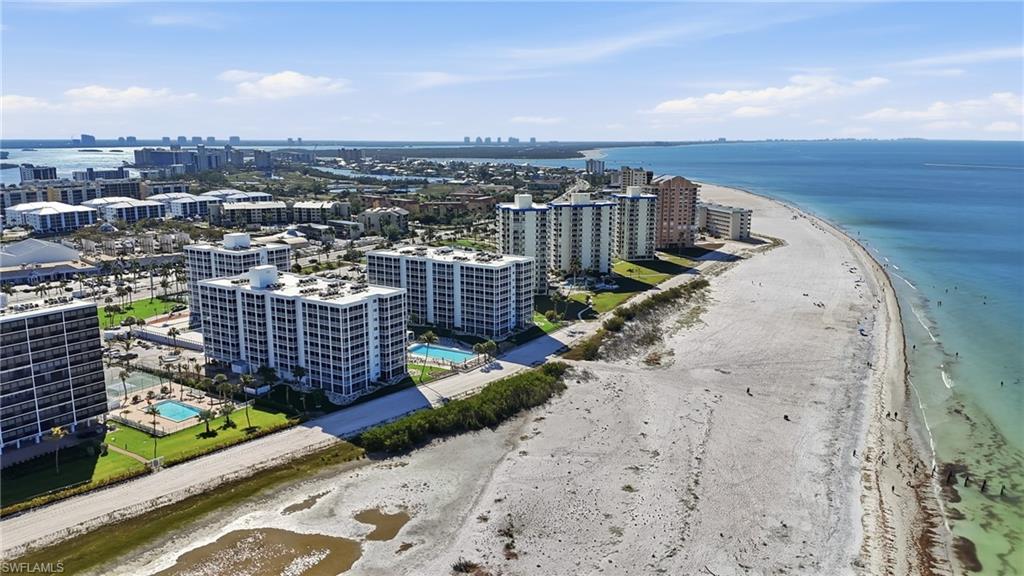 Coastal high-rise buildings featuring private balconies and multiple outdoor swimming pools