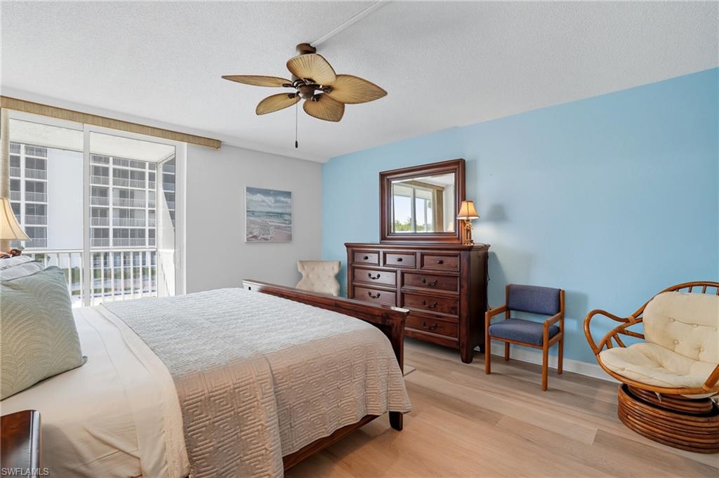 Light wood-finish flooring and a ceiling fan with integrated lighting