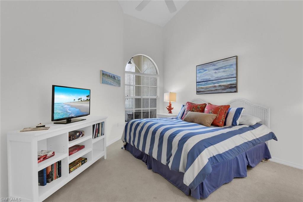 Bedroom with carpet floors, high vaulted ceiling, and ceiling fan