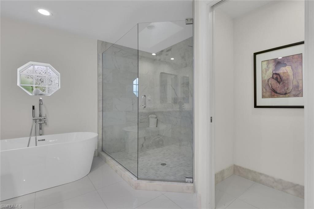 Full bath with a soaking tub, a marble finish shower, tile patterned floors, and recessed lighting