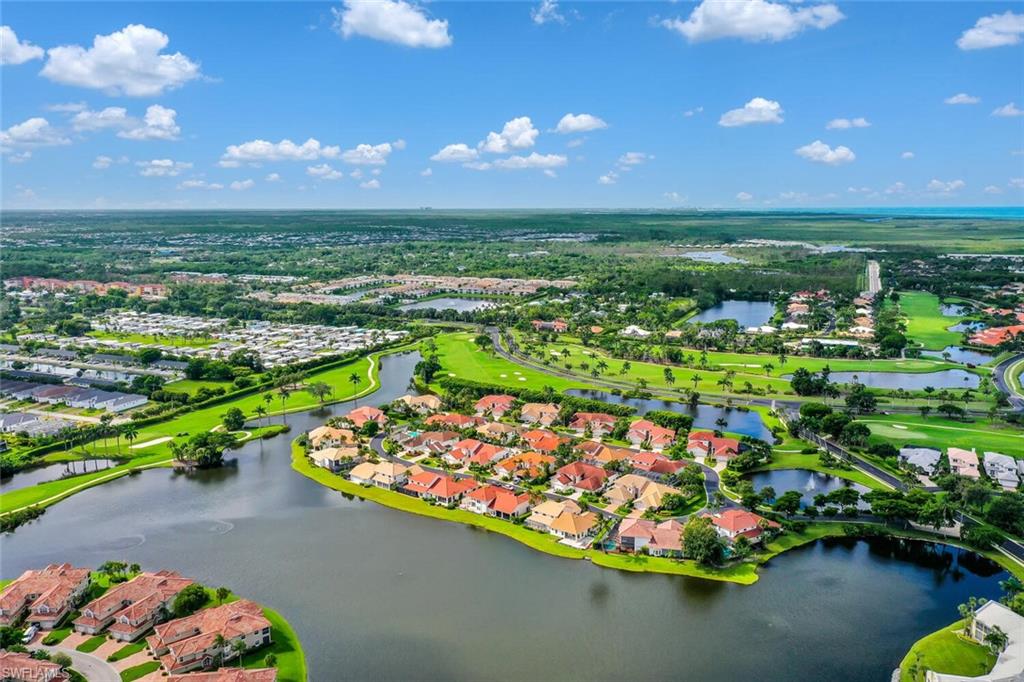 Aerial perspective of suburban area with a large body of water and a local golf course