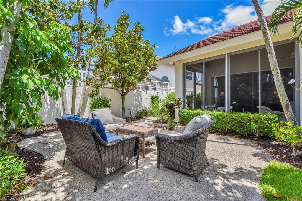 Fenced backyard featuring a patio area, a sunroom, and an outdoor living space