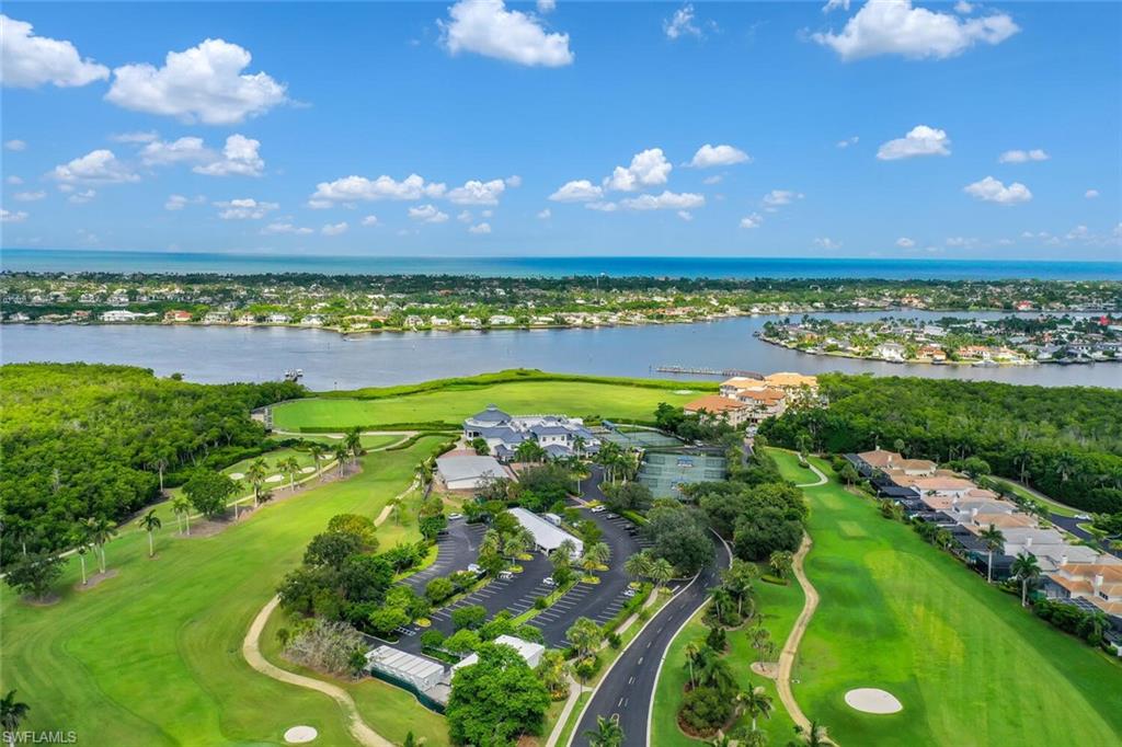 View of property location with a nearby body of water, a local golf course, and nearby suburban area