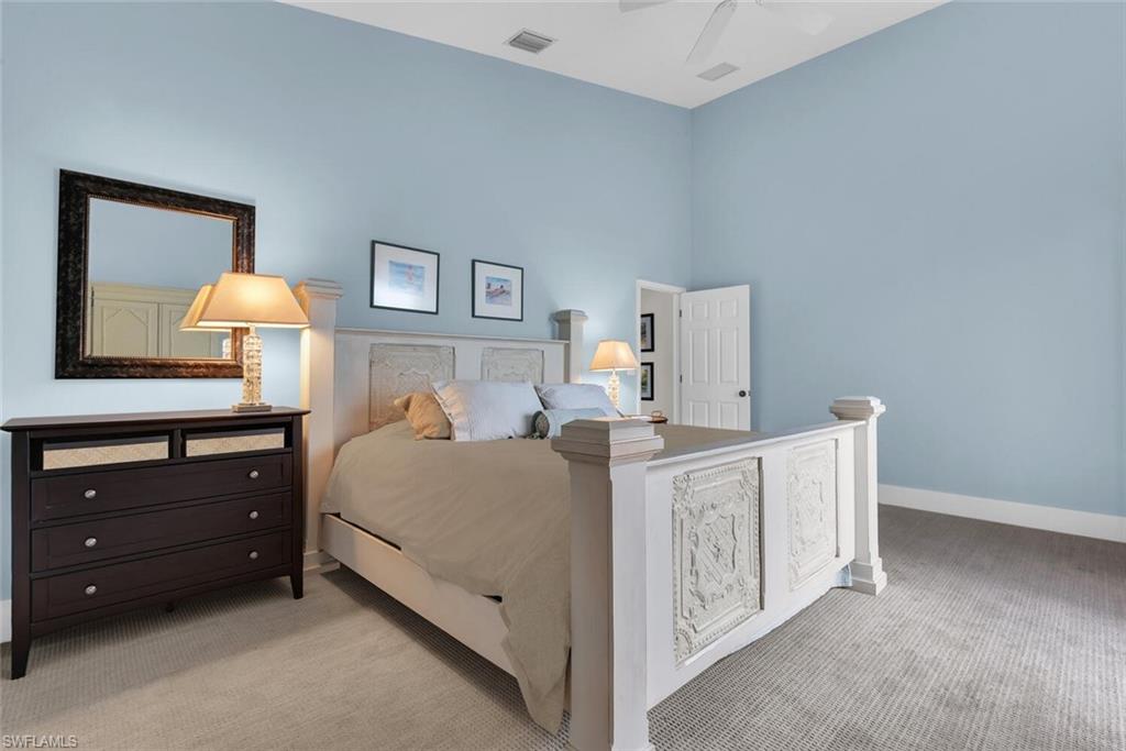 Bedroom with light colored carpet and baseboards