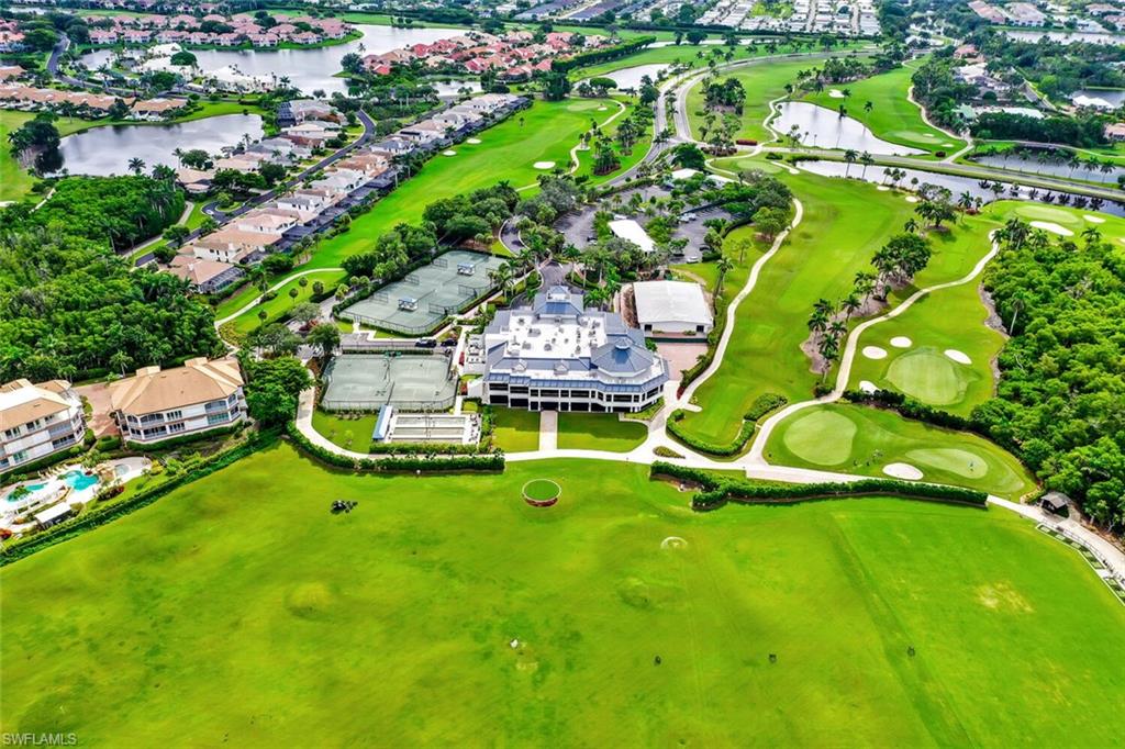 Aerial perspective of suburban area featuring a large body of water and a golf course