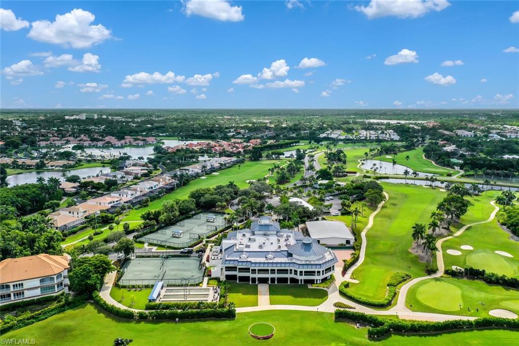Aerial perspective of suburban area with a golf club and a nearby body of water
