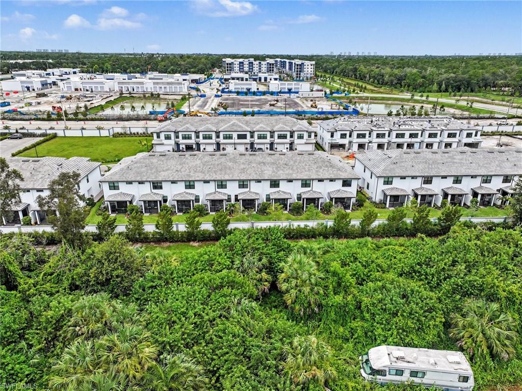 Contemporary townhomes featuring white exteriors and dark roofing