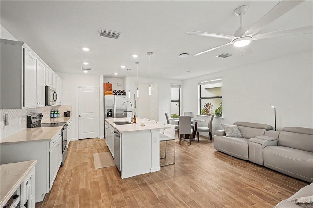 Open-concept living space featuring wood-finish flooring throughout
