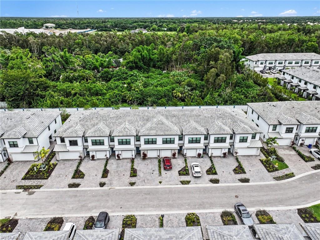 Modern townhome exteriors featuring white stucco finishes and gray tile roofs
