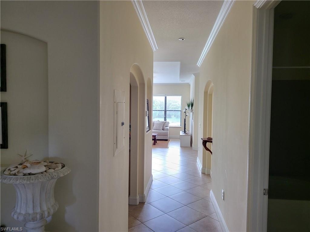 Hall to living area, tile on diagonal, tall ceilings.