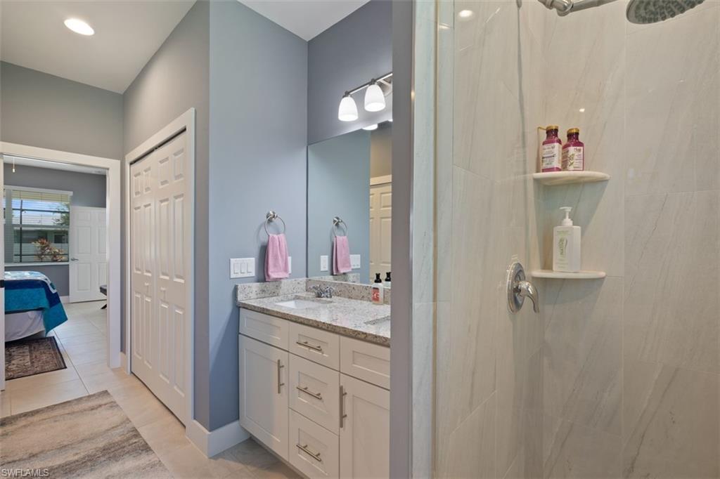 Ensuite bathroom with double vanity, walk in closet and shower