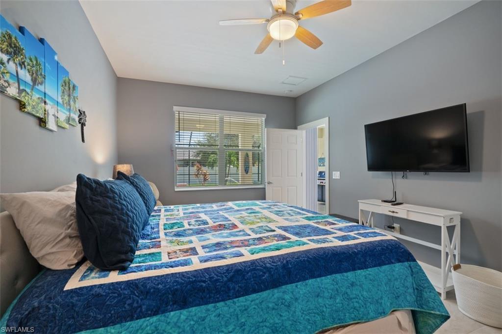 Bedroom featuring flatscreen tv and pool view