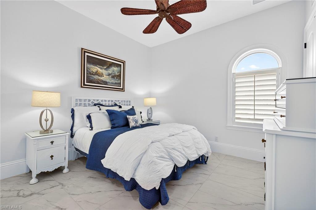 Bedroom with light marble finish flooring and ceiling fan