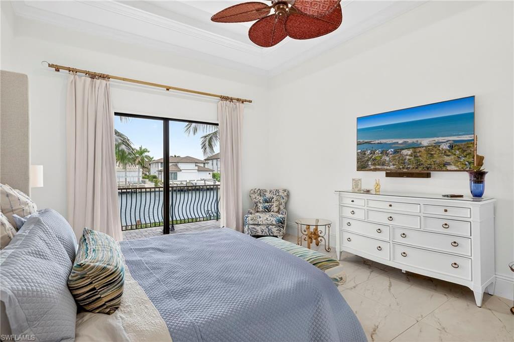 Bedroom featuring light marble finish flooring, access to outside, ceiling fan, and crown molding