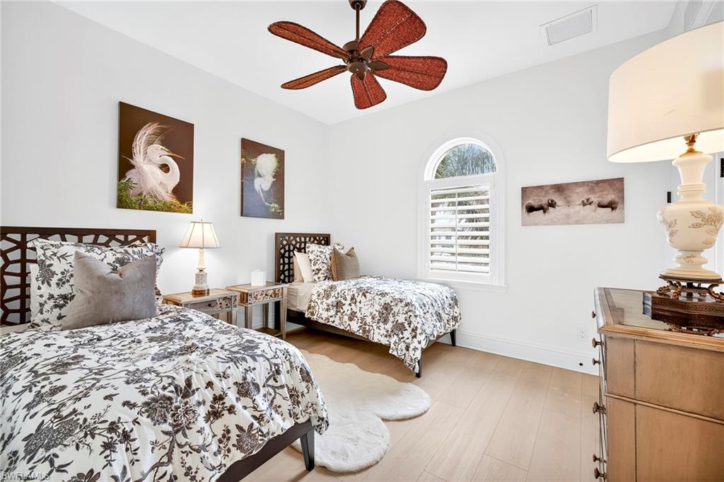 Bedroom with light wood-style flooring and ceiling fan