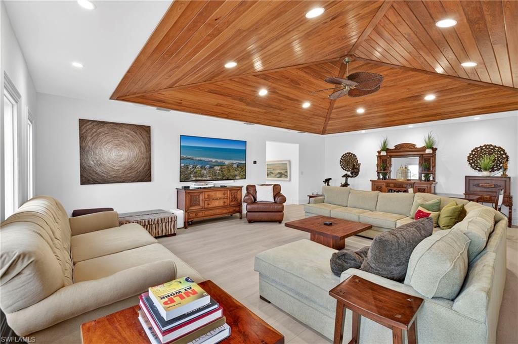 Living area featuring wooden ceiling, recessed lighting, a ceiling fan, and lofted ceiling