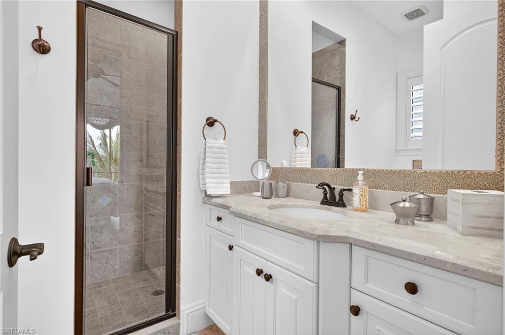 Full bath with a stall shower and vanity