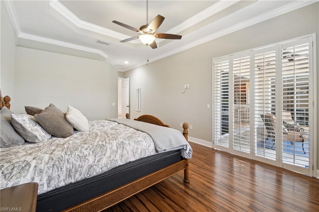 Wood-finish tile flooring complemented by a tray ceiling with crown molding
