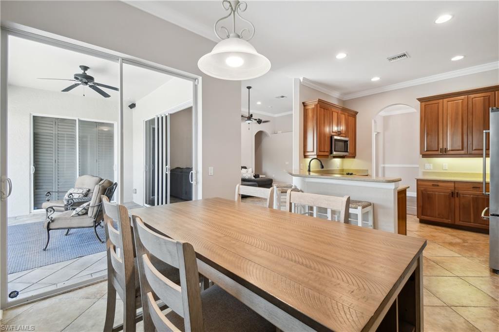 Open-concept dining area featuring a wood-finish dining table and tile flooring