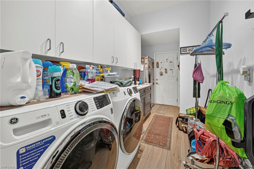 Interior laundry with new appliances, cabinetry and a sink