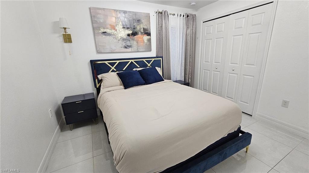 White tile flooring complements light-toned walls