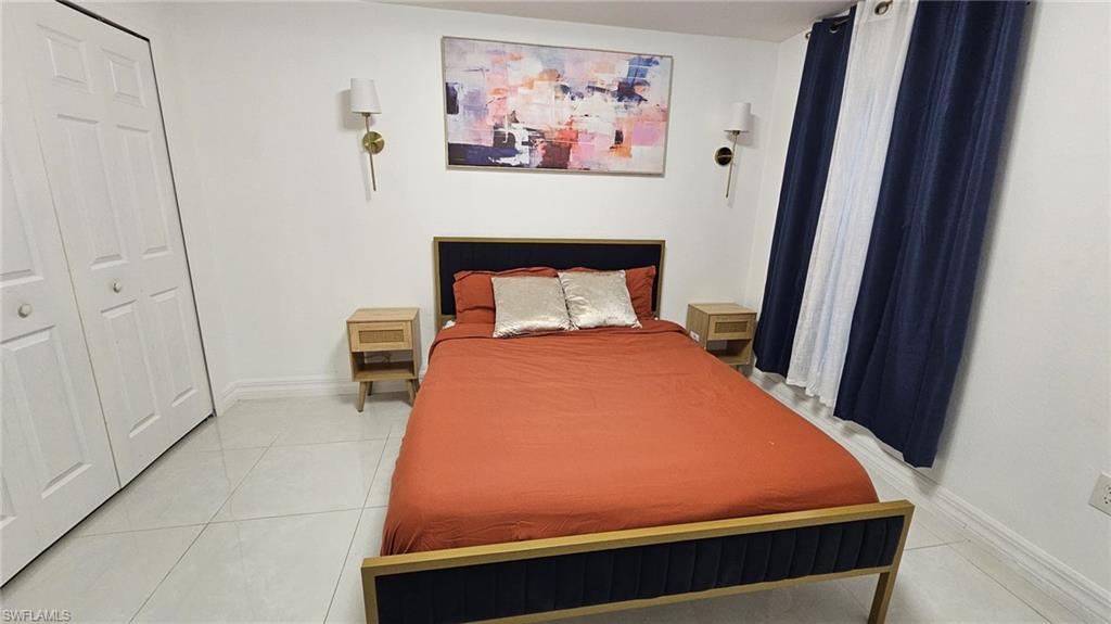 Bedroom featuring light-toned tile flooring and white walls