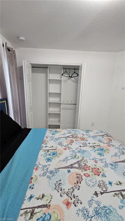 Built-in closet with bifold doors, shelving, and hanging rods