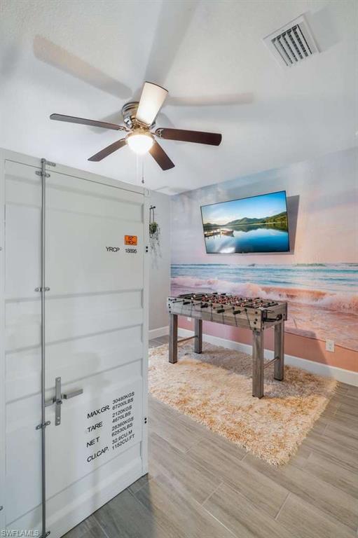 Recreation room with a ceiling fan