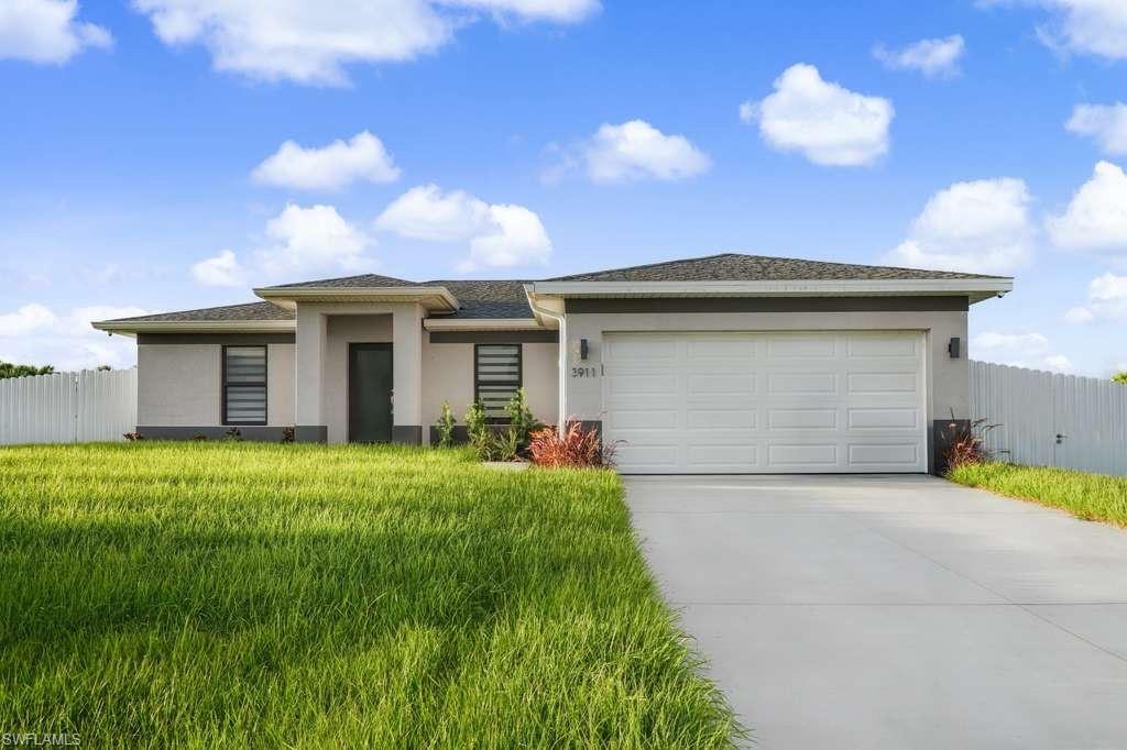 Prairie-style home with stucco siding, concrete driveway, and a garage