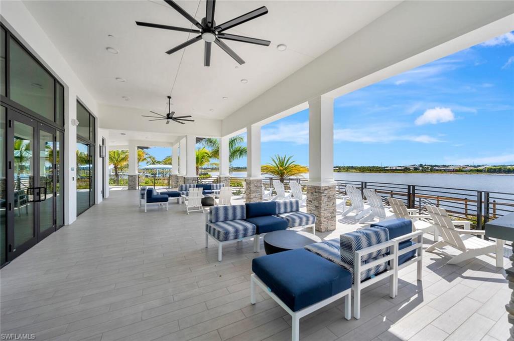 View of terrace featuring a water view, an outdoor hangout area, and ceiling fan
