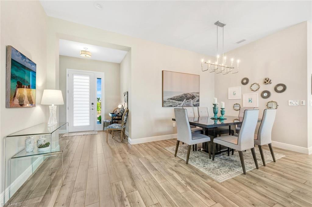 Dining area featuring light hardwood / wood-style flooring and an inviting chandelier