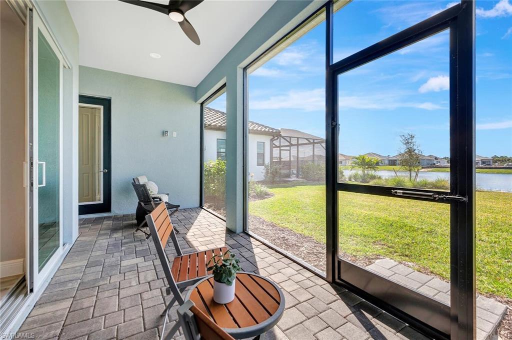 Sunroom / solarium with a water view and ceiling fan