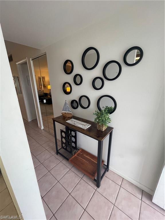 Hallway featuring light tile patterned floors