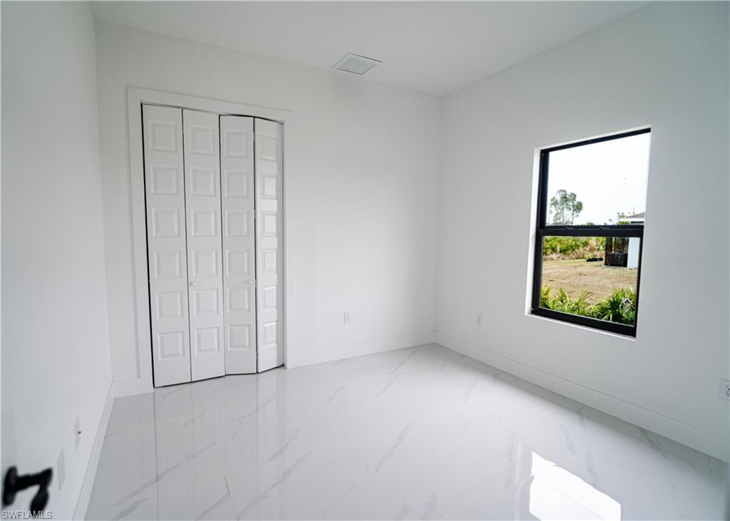 White interior with marble-look tile flooring