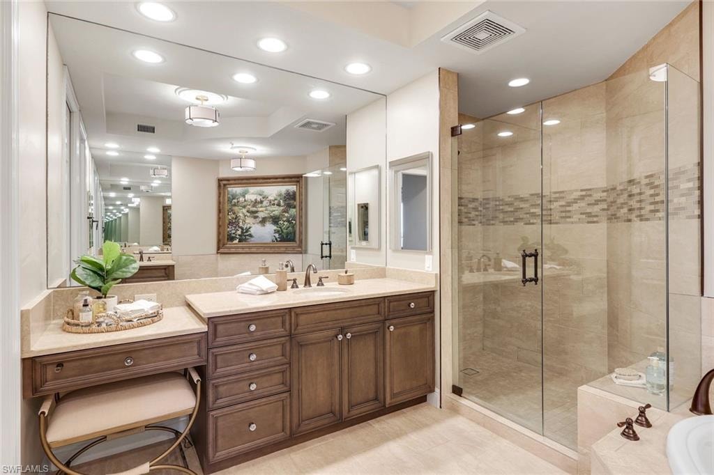 Updated bath with quartz counters, vanity area & frameless glass shower
